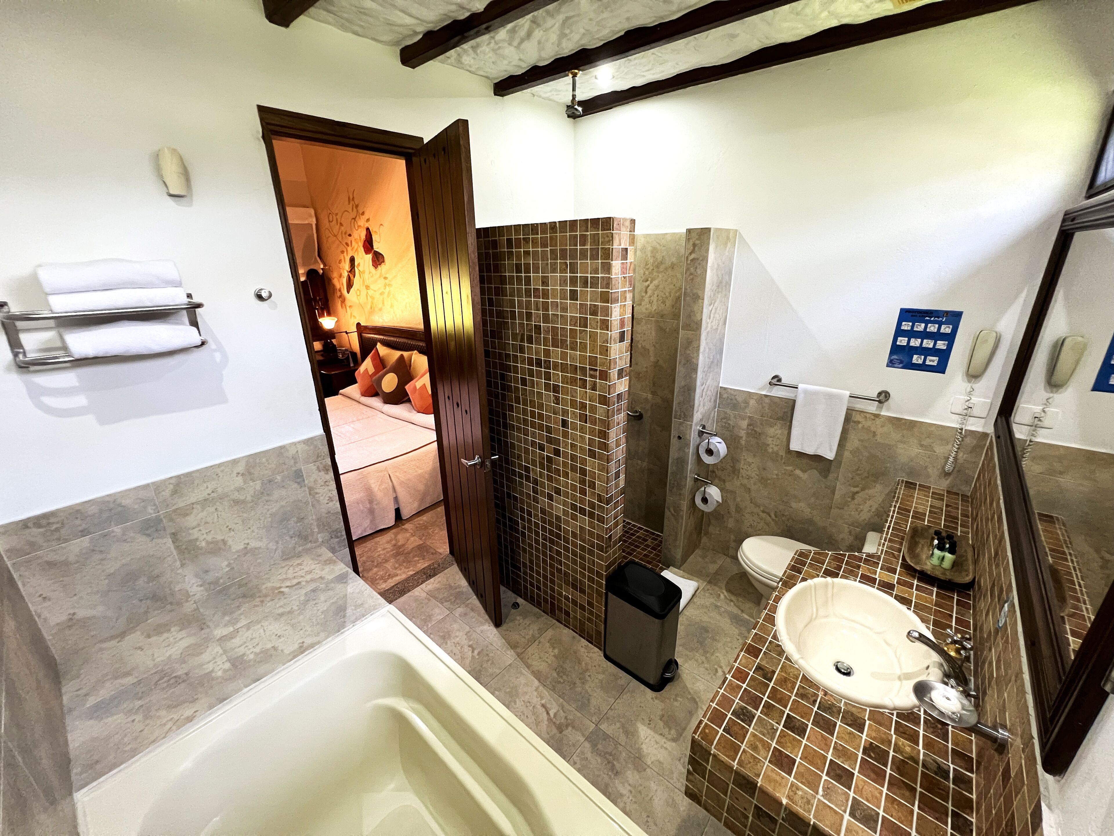 A bathroom with a bathtub, toilet, and sink.