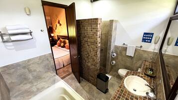 A bathroom with a bathtub, toilet, and sink.