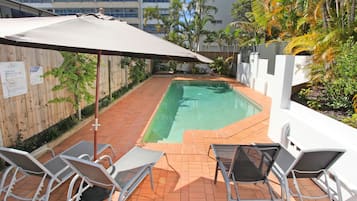 Outdoor pool, a heated pool, pool umbrellas, pool loungers