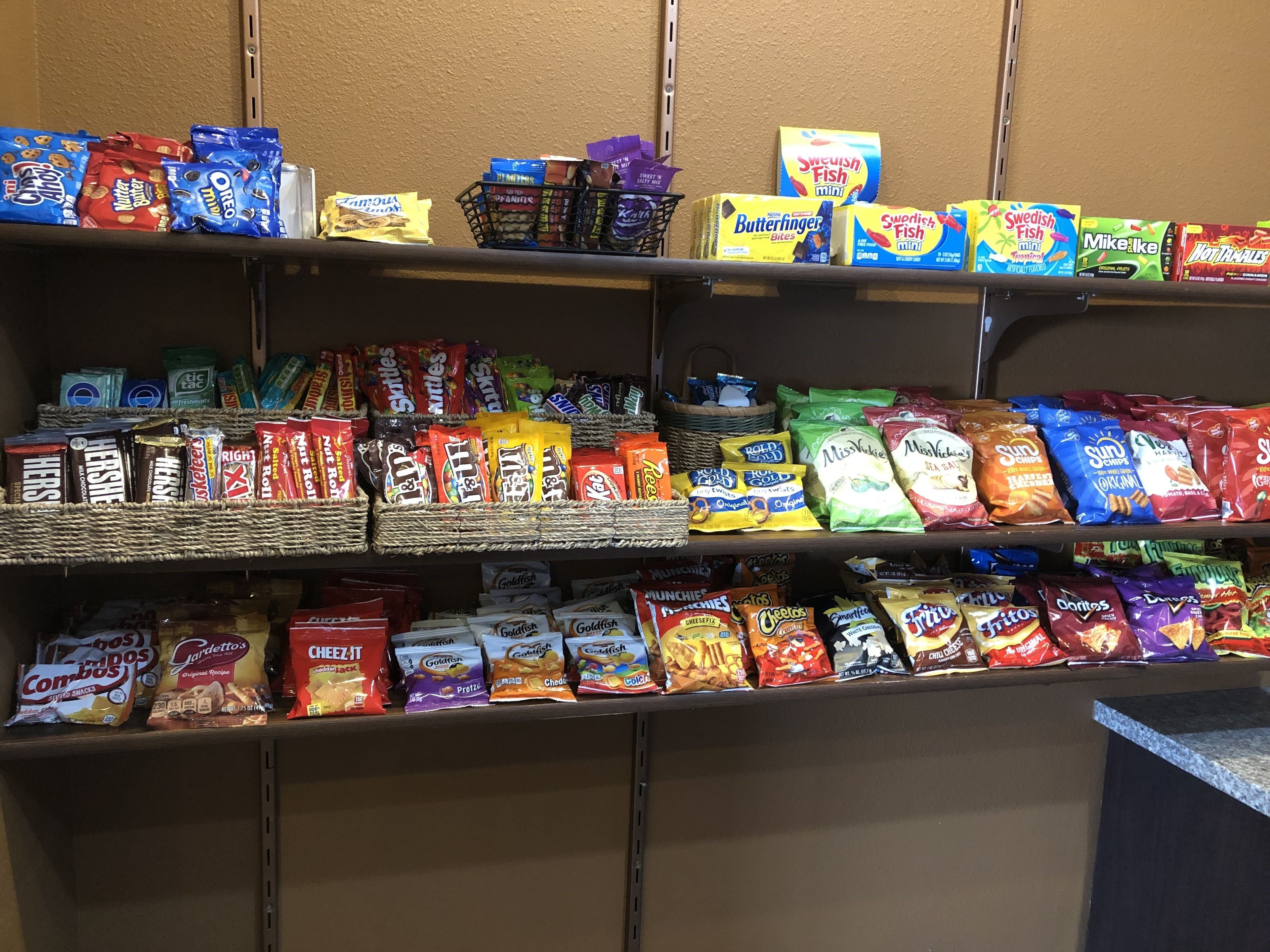 Shelves stocked with various snack items including chips, cookies, and candy.