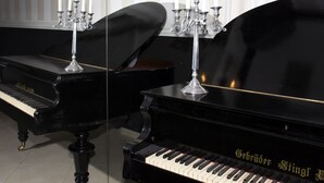 A grand piano with a candelabra and a mirror reflecting the piano. - Dash Hotel (Novi Sad)