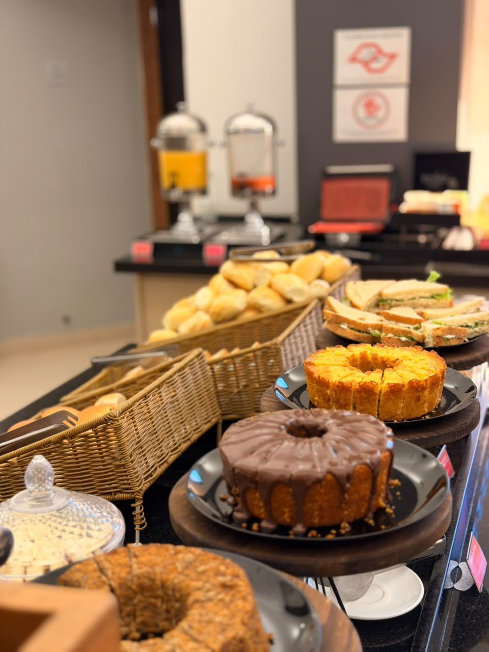 A buffet with various baked goods and sandwiches.