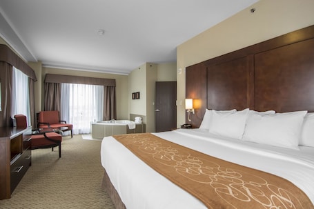 In-room safe, desk, laptop workspace, blackout drapes. Comfort Suites Saskatoon