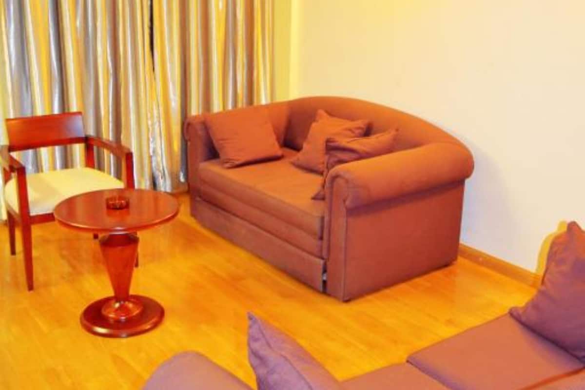A living room with a sofa, a chair, and a small table.