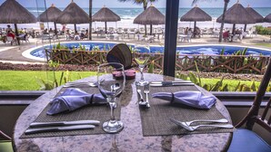 Ein Tisch für zwei Personen mit Blick auf Strand und Meer.