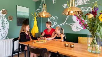 Enjoy meals together with family and friends in this cozy dining area, featuring a table set for four and a board game.