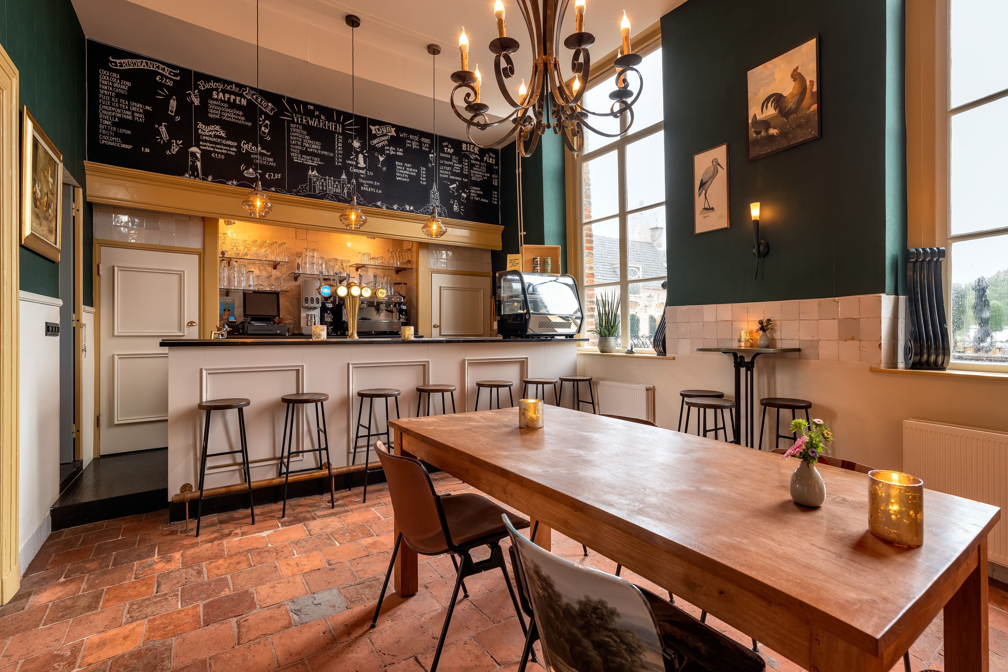 A restaurant with a chalkboard menu, bar area, and a wooden dining table with chairs.