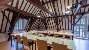 A large, open-plan dining area with high ceilings and exposed wooden beams. Tables are set with chairs, and the space is well-lit by natural light from large windows. - Stayokay Utrecht Bunnik - Hostel (Bunnik)