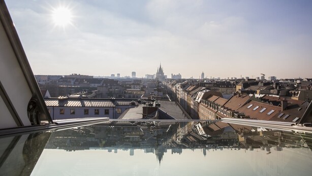 A cityscape viewed from a high vantage point, including a prominent building with a spire. - City Aparthotel Muenchen (Muenchen)