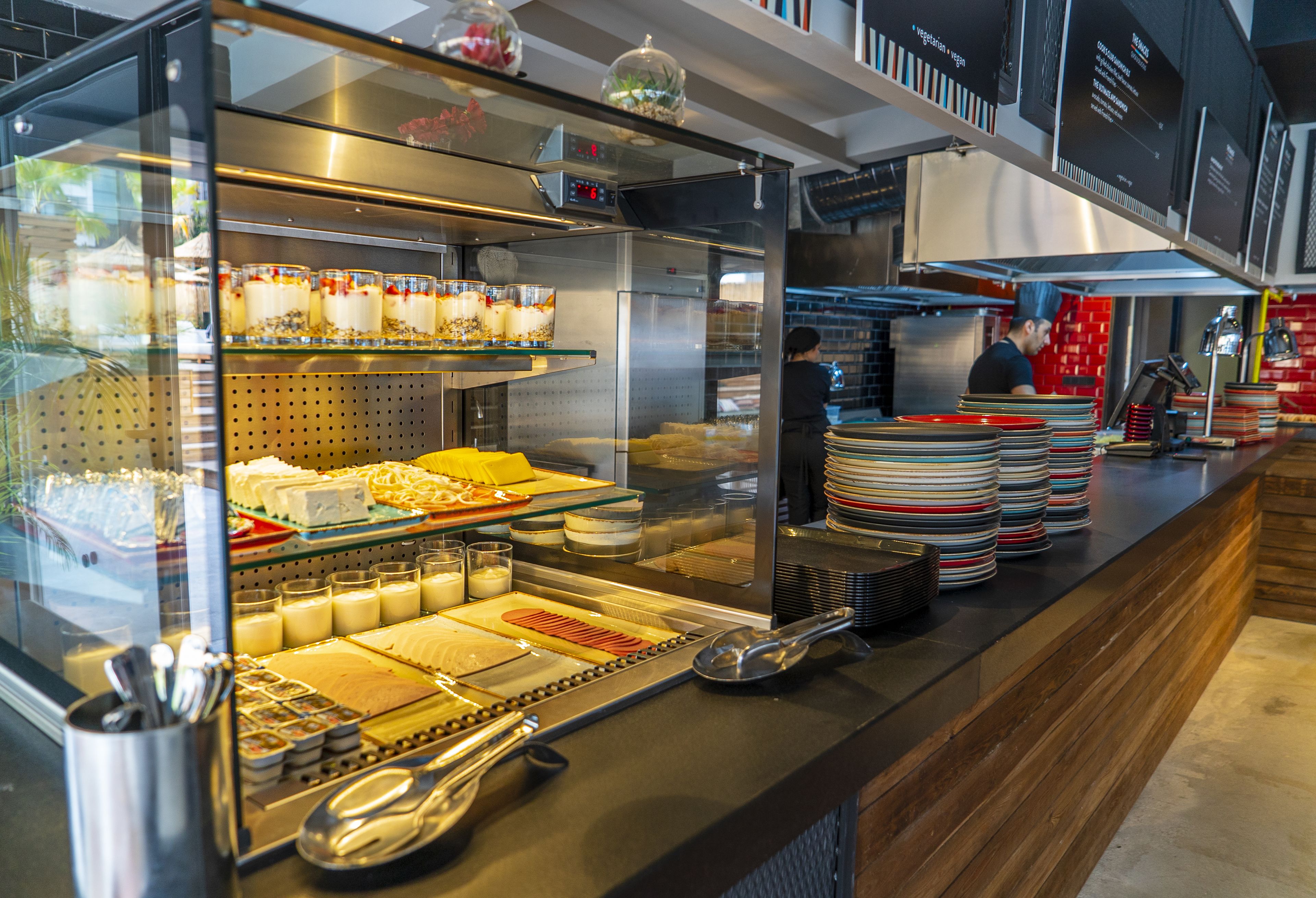 A buffet area with various food items and utensils.