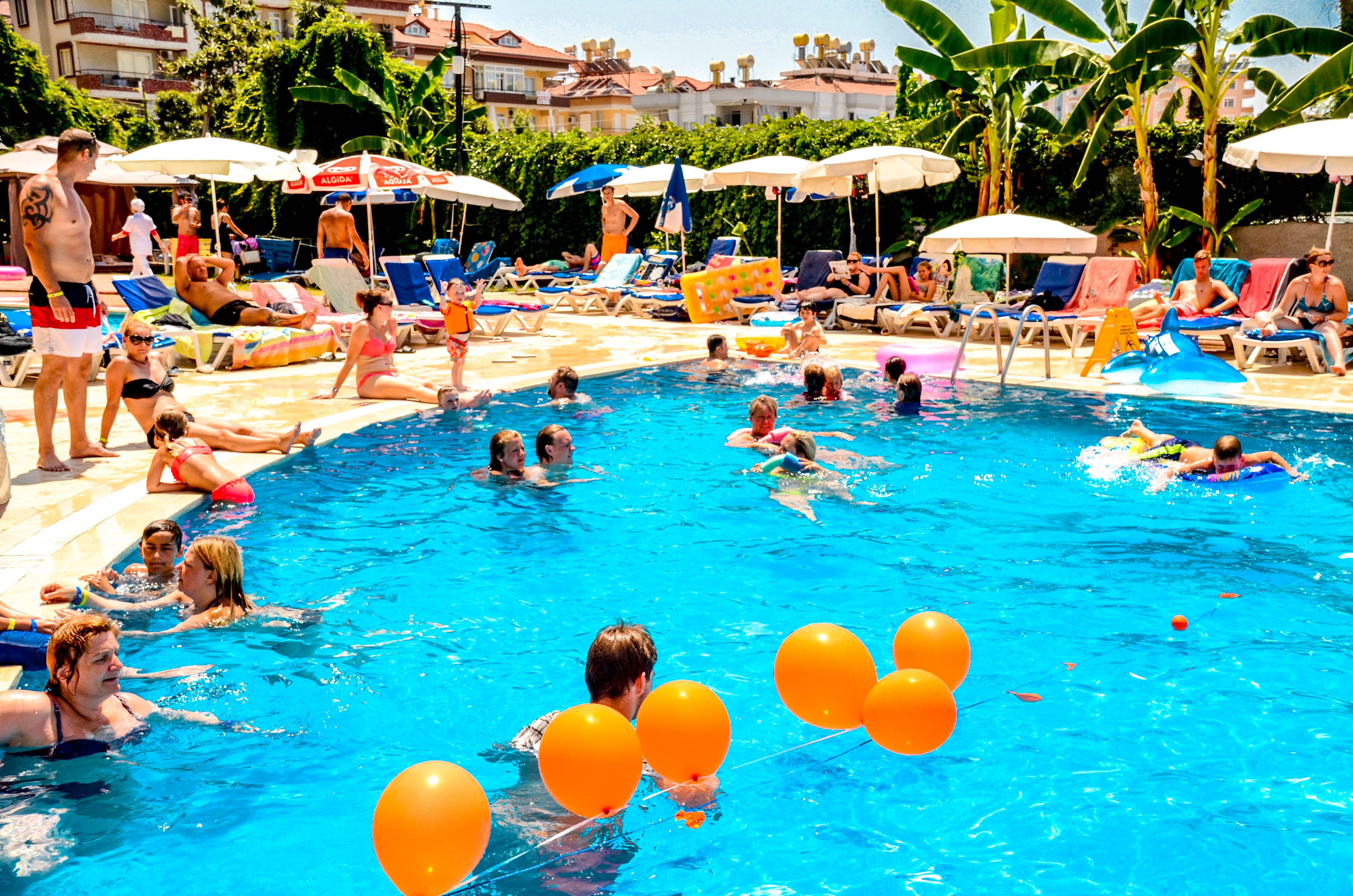 seasonal outdoor pool, open 8:00 am to 7:00 pm, pool umbrellas