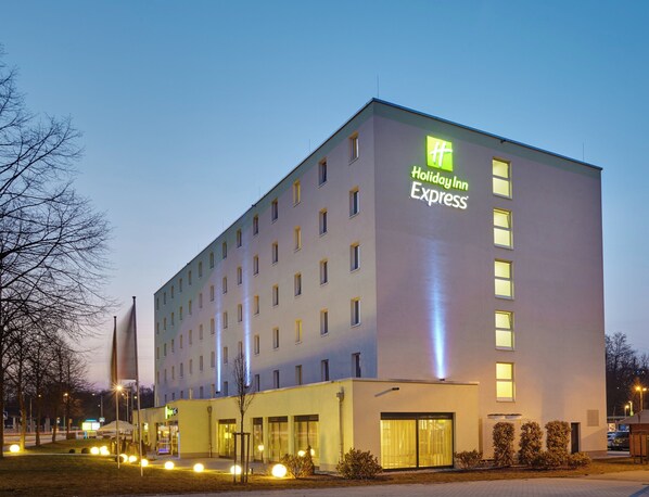 A Holiday Inn Express building with a modern design, featuring a flat roof and a series of windows.