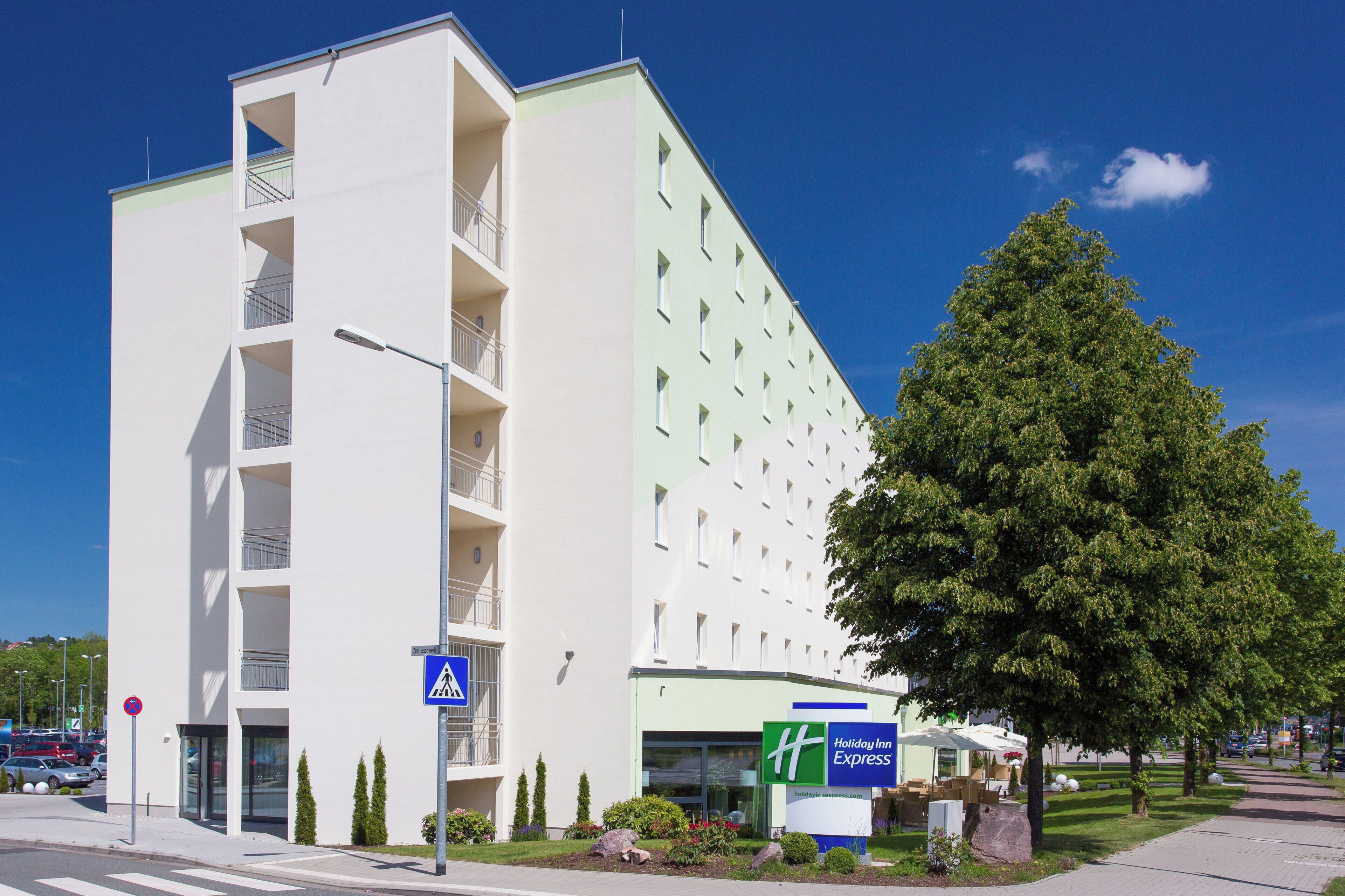A modern hotel with a flat facade, a visible entrance, and a Holiday Inn Express sign.