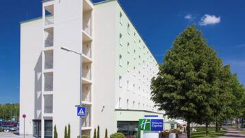 A modern hotel with a flat facade, a visible entrance, and a Holiday Inn Express sign.