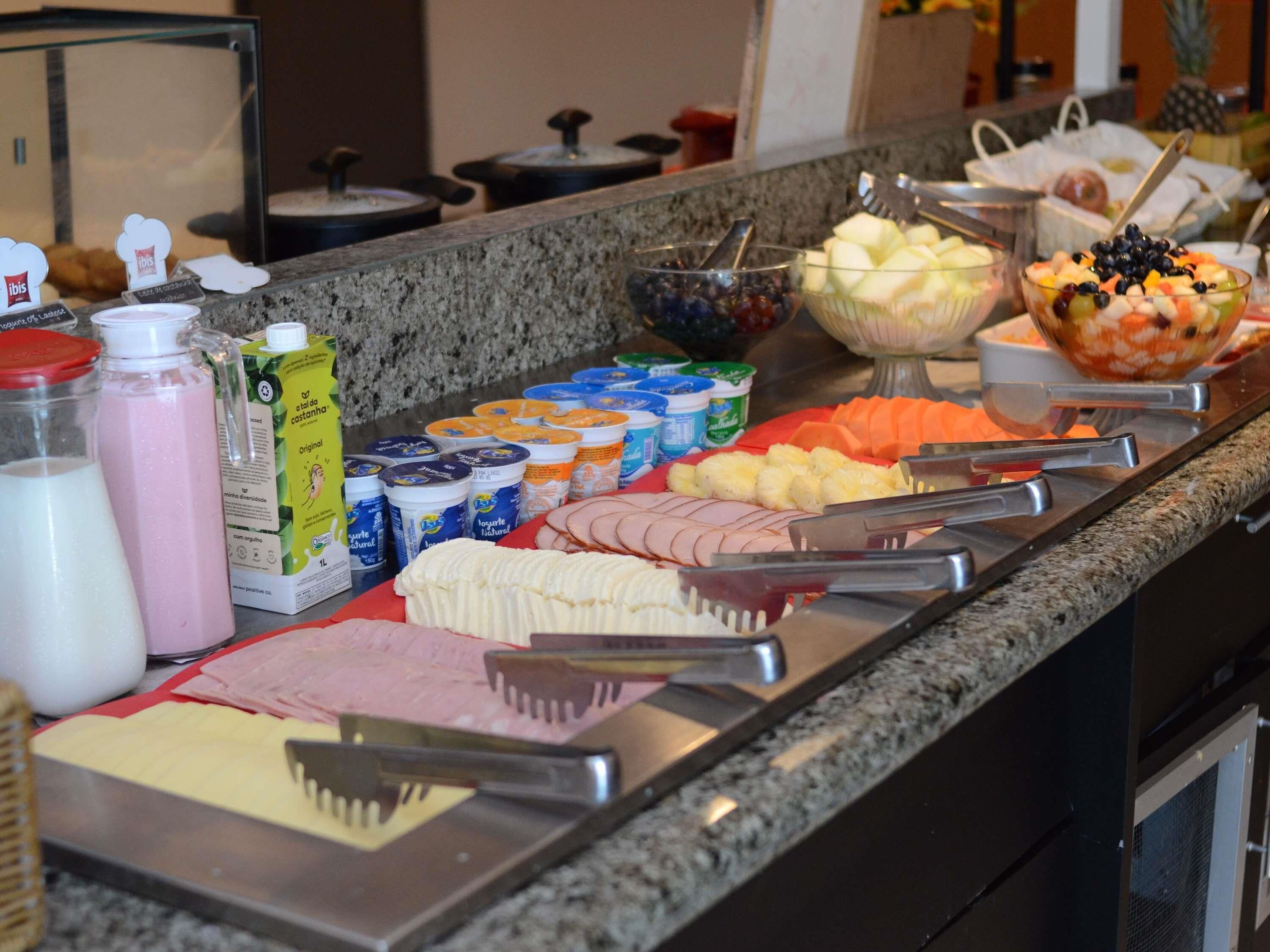 A buffet with various food items and beverages.