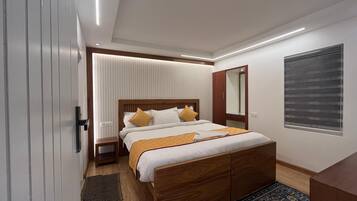 A modern bedroom with a wooden bed, white bedding, and a patterned rug.