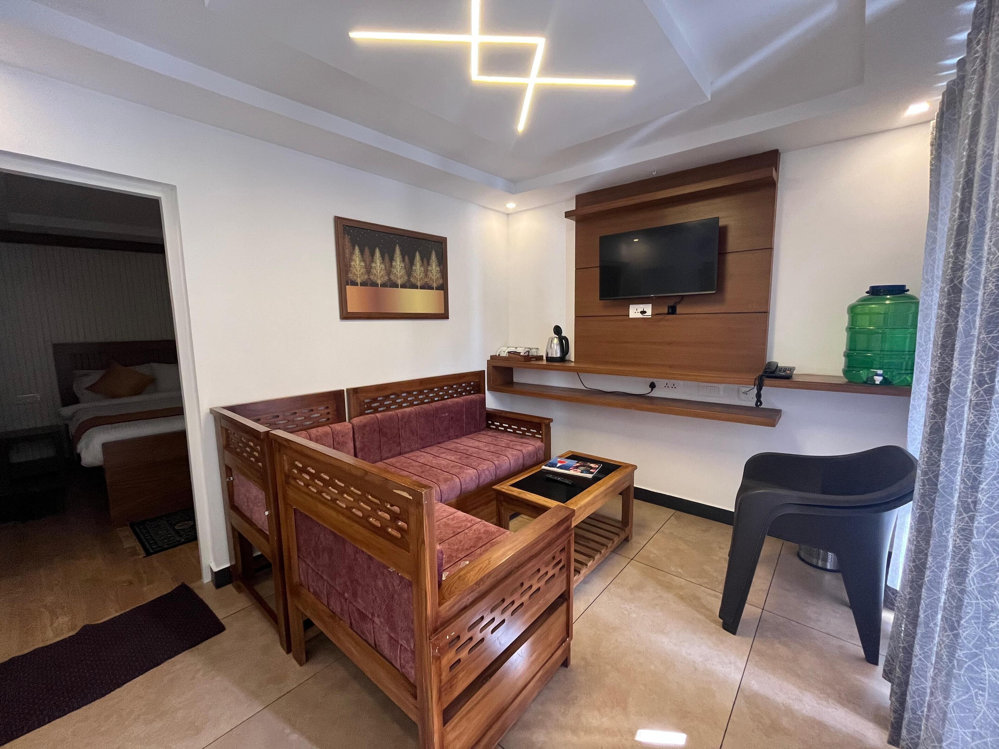 Deluxe Double Room | Living area | 32-inch LED TV with cable channels