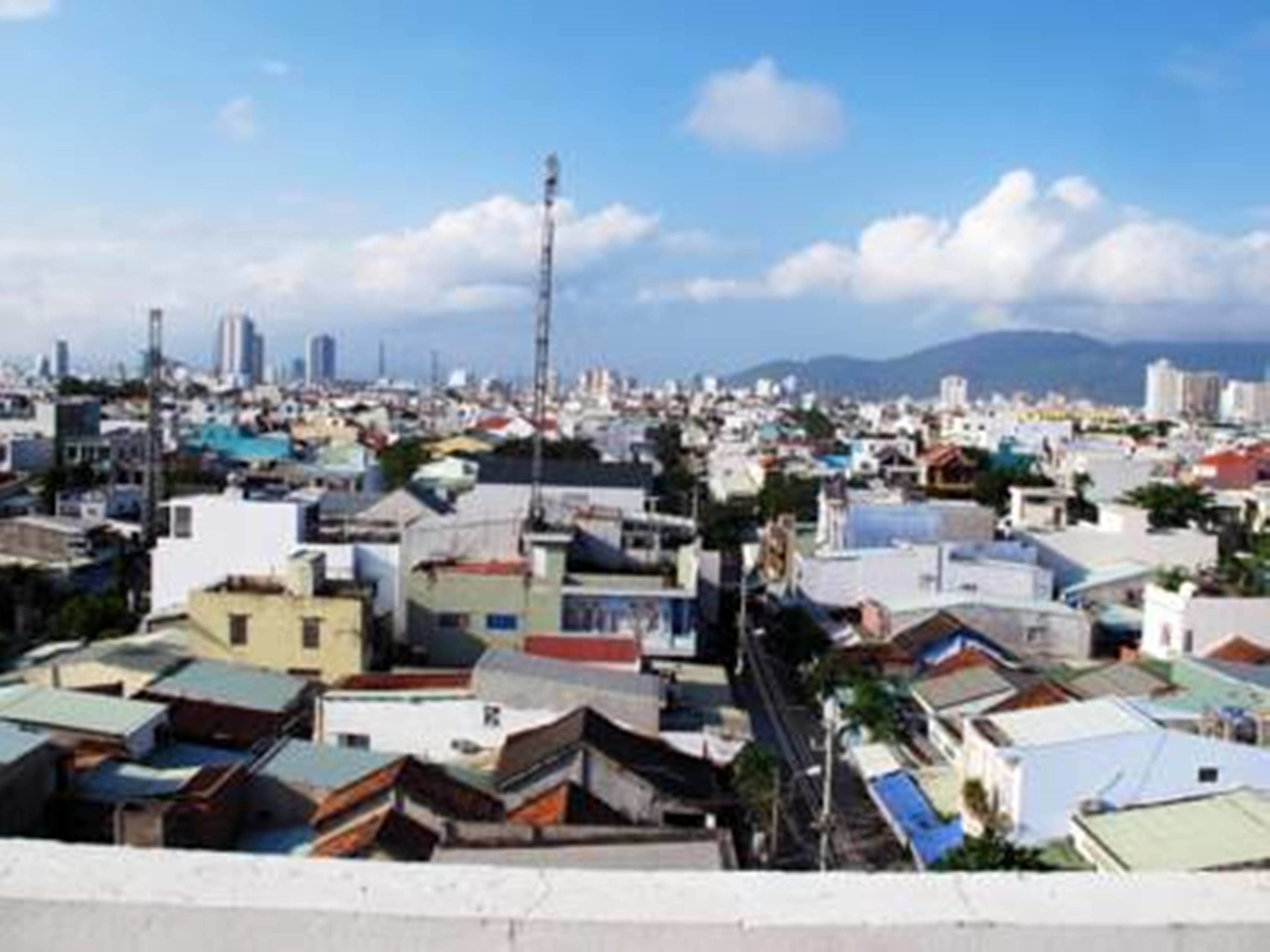 A densely packed urban area with numerous buildings and a clear sky.