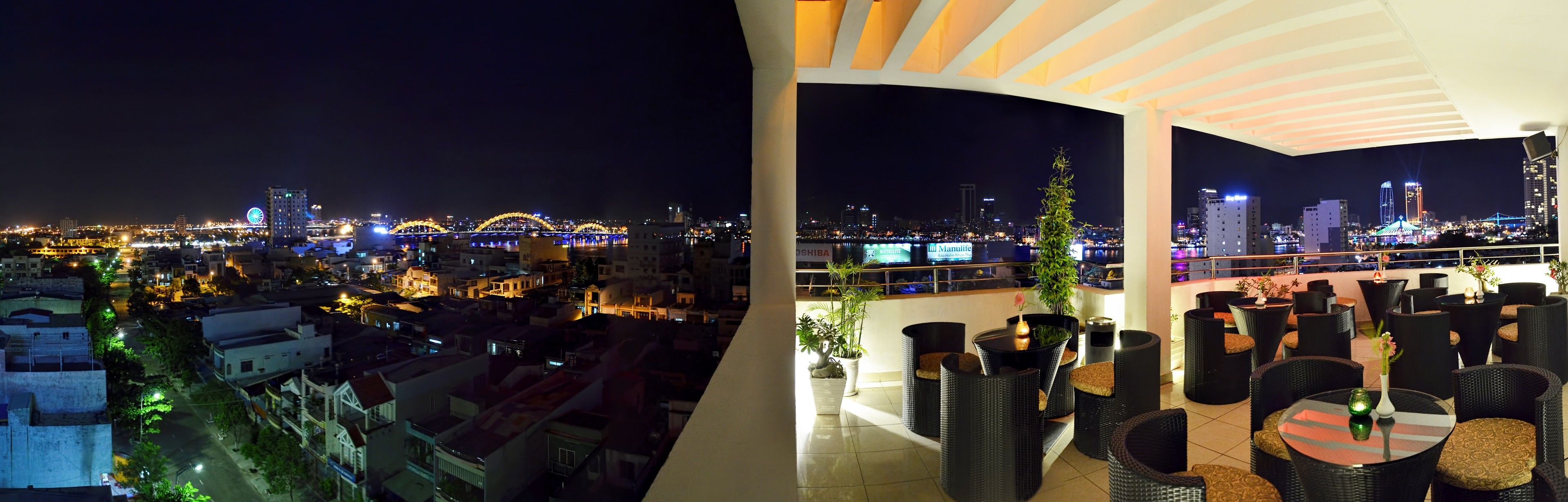 A night view of a cityscape with illuminated bridges and buildings.