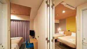 A hotel room with two beds, a desk with a chair, a television, and a bathroom door. - Sotetsu Fresa Inn Tokyo Tamachi (Tokyo)