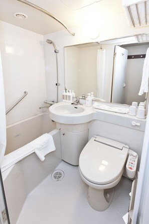 A modern bathroom with a shower, sink, toilet, and handrails. - Sotetsu Fresa Inn Tokyo Tamachi (Tokyo)
