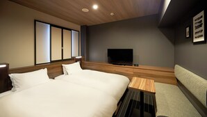 A hotel room with a large bed, a television, a small table, and a sofa. - Sotetsu Fresa Inn Nihombashi Kayabacho (Tokyo)