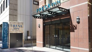 A hotel entrance with a sign reading "FRESA INN" and a smaller sign below it. - Sotetsu Fresa Inn Nihombashi Kayabacho (Tokyo)