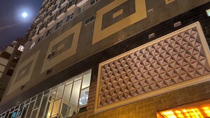 A high-rise building with multiple floors, large windows, and a geometric facade design. - Ramada Grand Tsim Sha Tsui (Former Ramada Hong Kong Grand Tsim Sha Tsui) (Kowloon)