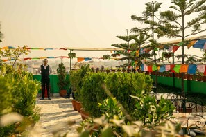 A rooftop garden with potted plants and a person standing. - Hotel Nepalaya (Kathmandu)