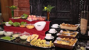 A buffet table with various food items and condiments. - Thamel Eco Resort (Kathmandu)