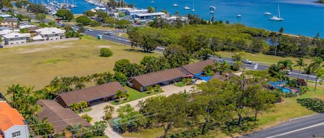 A coastal area with a marina, houses, and a road.