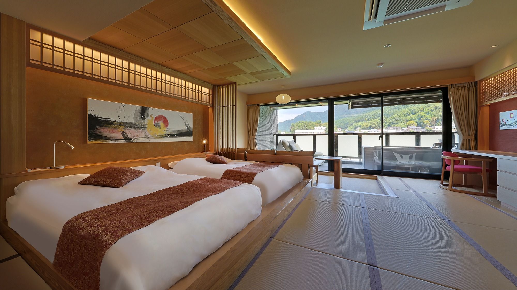 A hotel room with two beds, a desk, a chair, a large window with a view, and a painting on the wall.