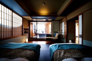 A hotel room with two beds, a television, a sliding door, and a view of the outside. - Aburaya Tosen (Yamanouchi)