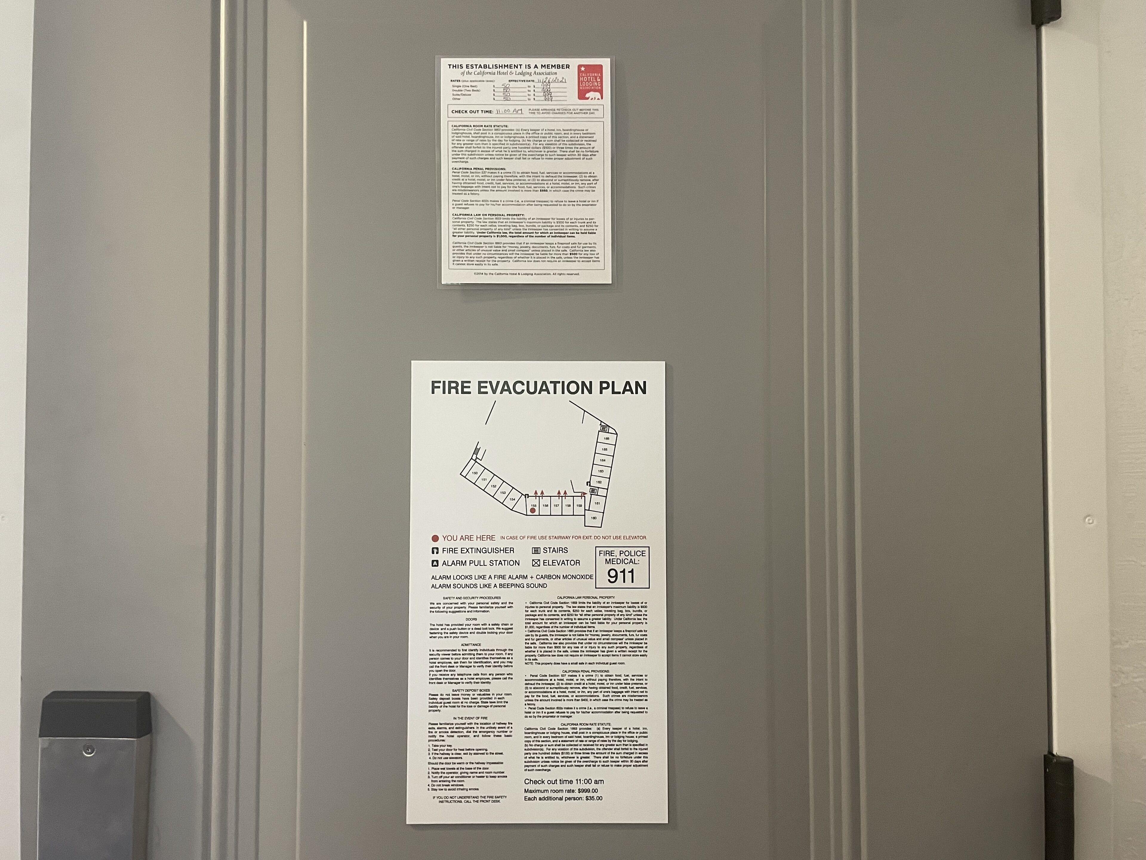 A fire evacuation plan and a membership card on a door.