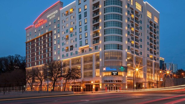 A multi-story hotel with a prominent entrance and a curved facade. - Homewood Suites by Hilton Atlanta Midtown, GA (Atlanta)