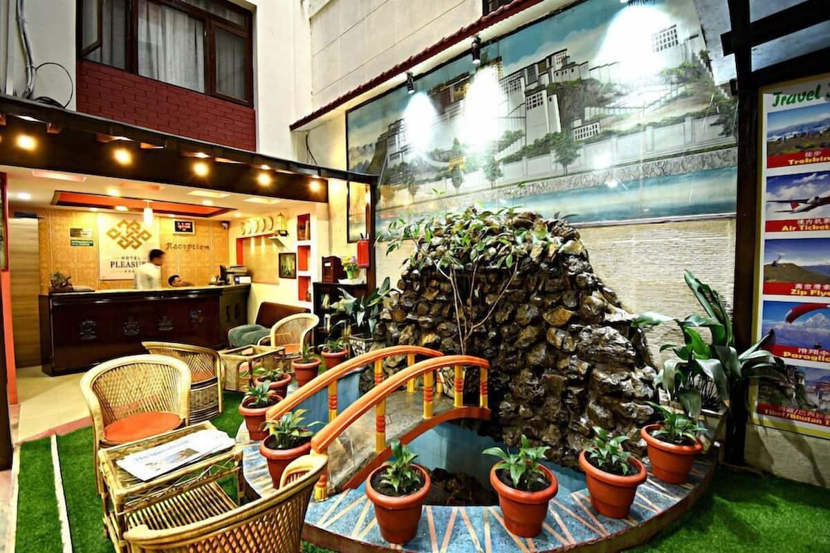 A reception area with a desk, chairs, and a decorative rock wall.