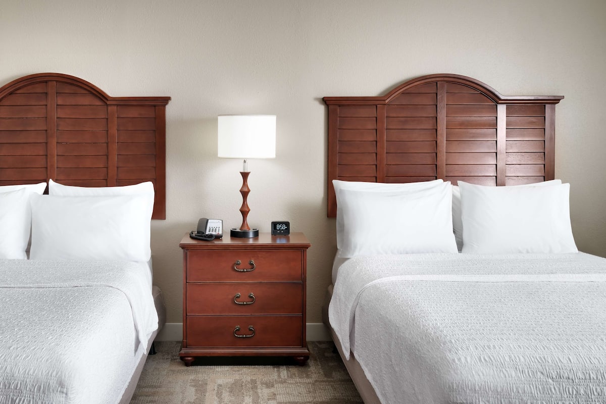 Hypo-allergenic bedding, desk, laptop workspace, blackout drapes