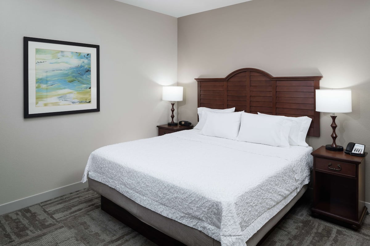 Hypo-allergenic bedding, desk, laptop workspace, blackout drapes