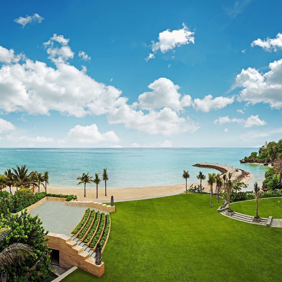 A resort with a pool, beach, and ocean view.