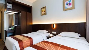A hotel room with two beds, a desk, and a mirror. - 56 Hotel (Kuching)