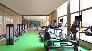 A gym with treadmills, elliptical machines, and weight machines.