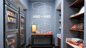 A snack bar with refrigerated display cases and a wooden counter with snacks. - Hampton Inn Cleveland, TN (Cleveland)