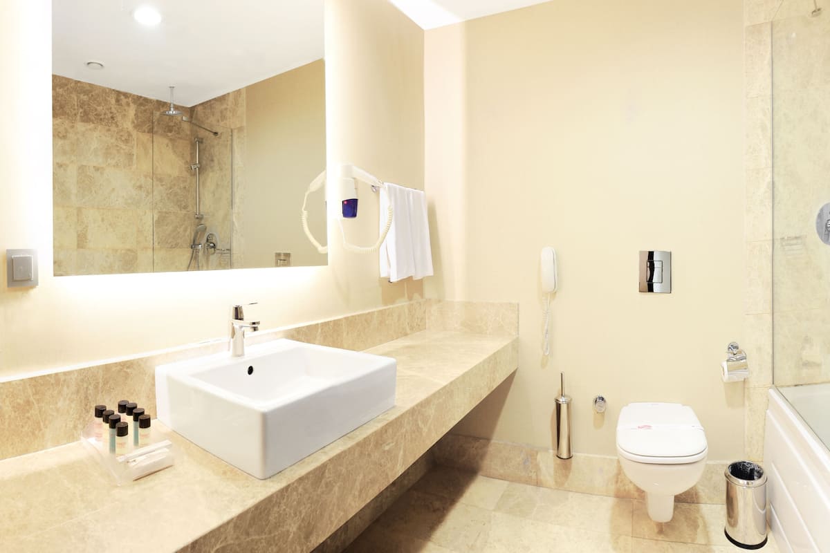 shower, hair dryer, slippers, towels