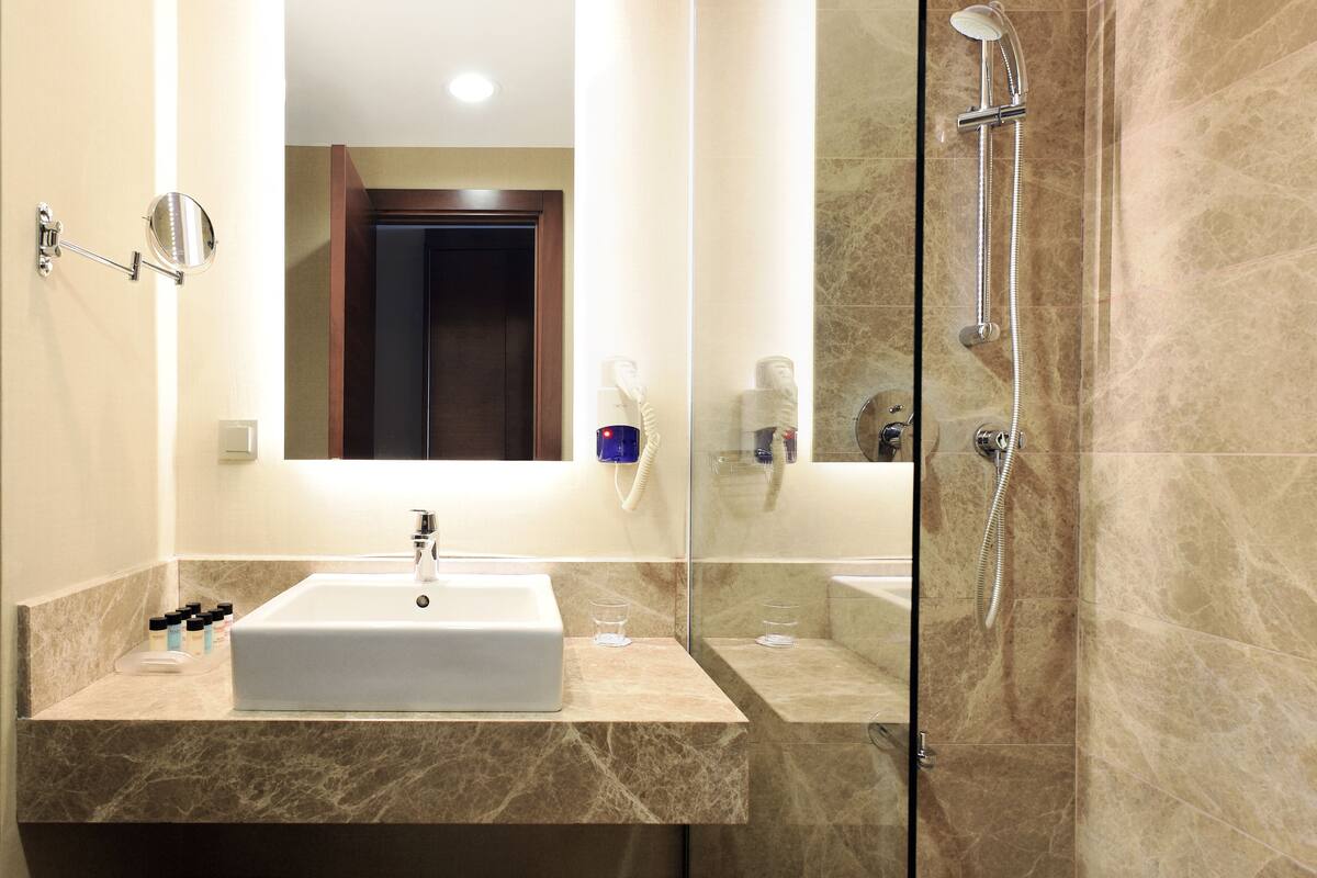 shower, hair dryer, slippers, towels