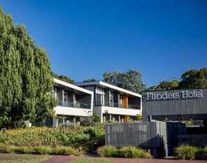 A modern hotel with a flat roof, large windows, and a sign reading "Finders Hotel".