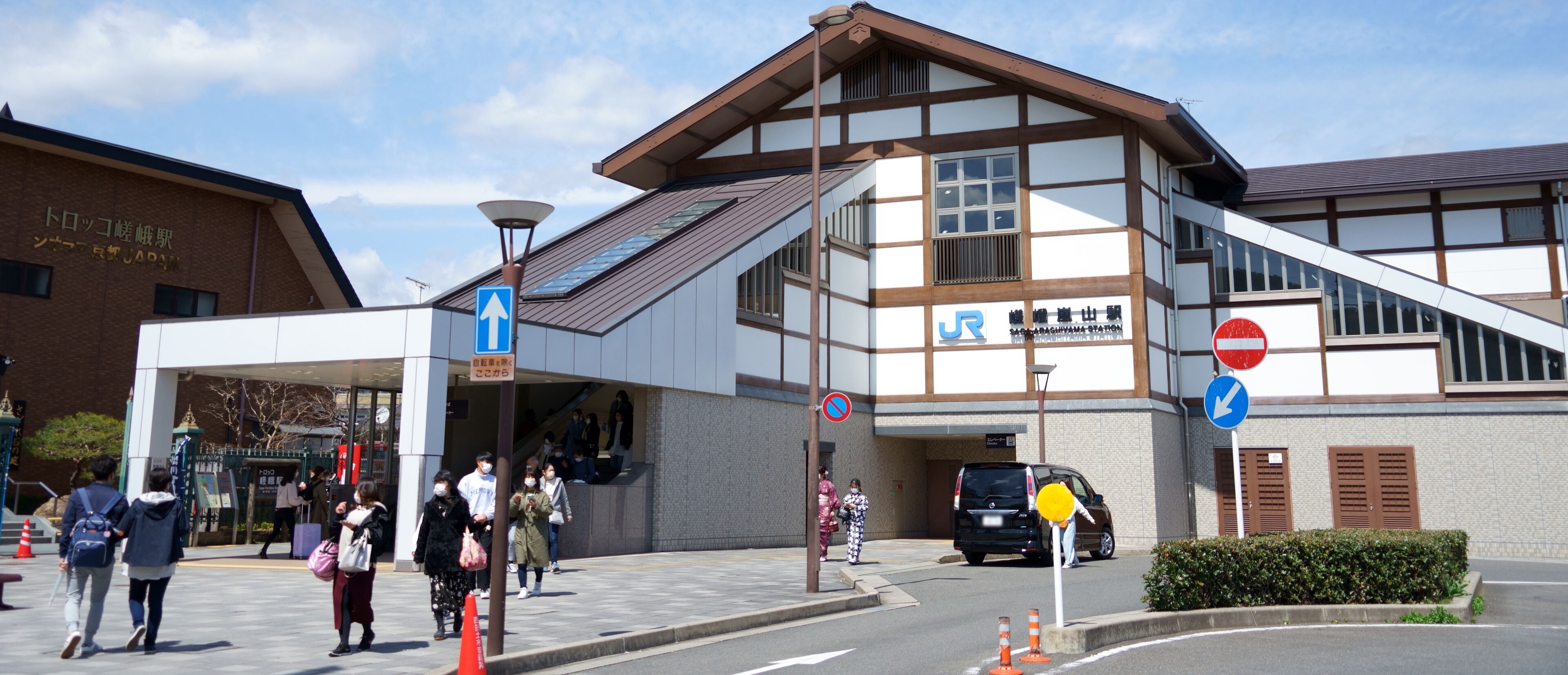 A building with a traditional architectural style, a covered entrance, and a sign indicating a no entry for vehicles.