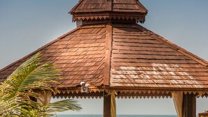 A wooden gazebo with a peaked roof overlooking a beach. - Grand Sea Beach Resort (Ko Pha-ngan)