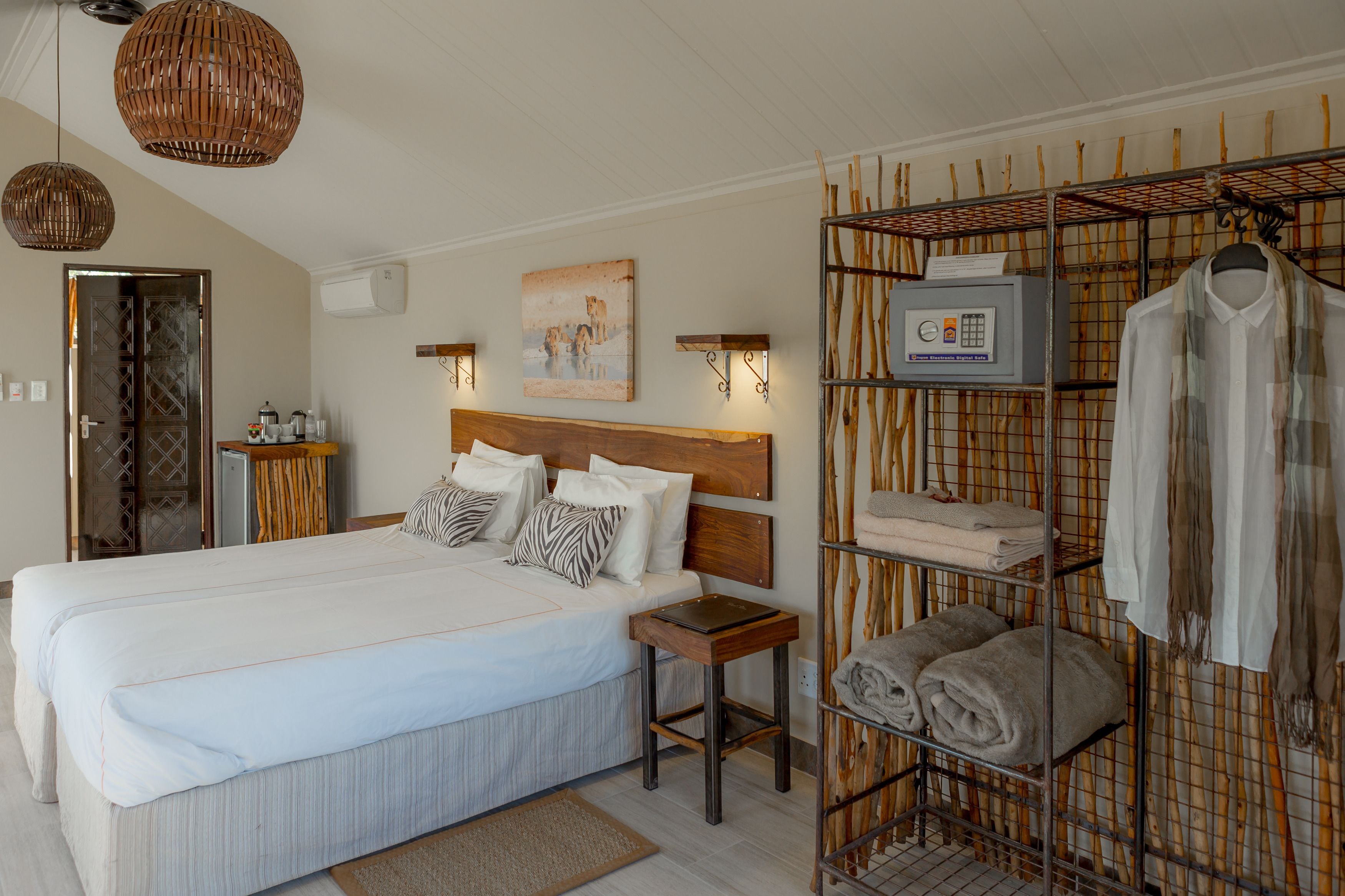 A bedroom with a large bed, bedside tables, a wardrobe, and a wall-mounted heater.