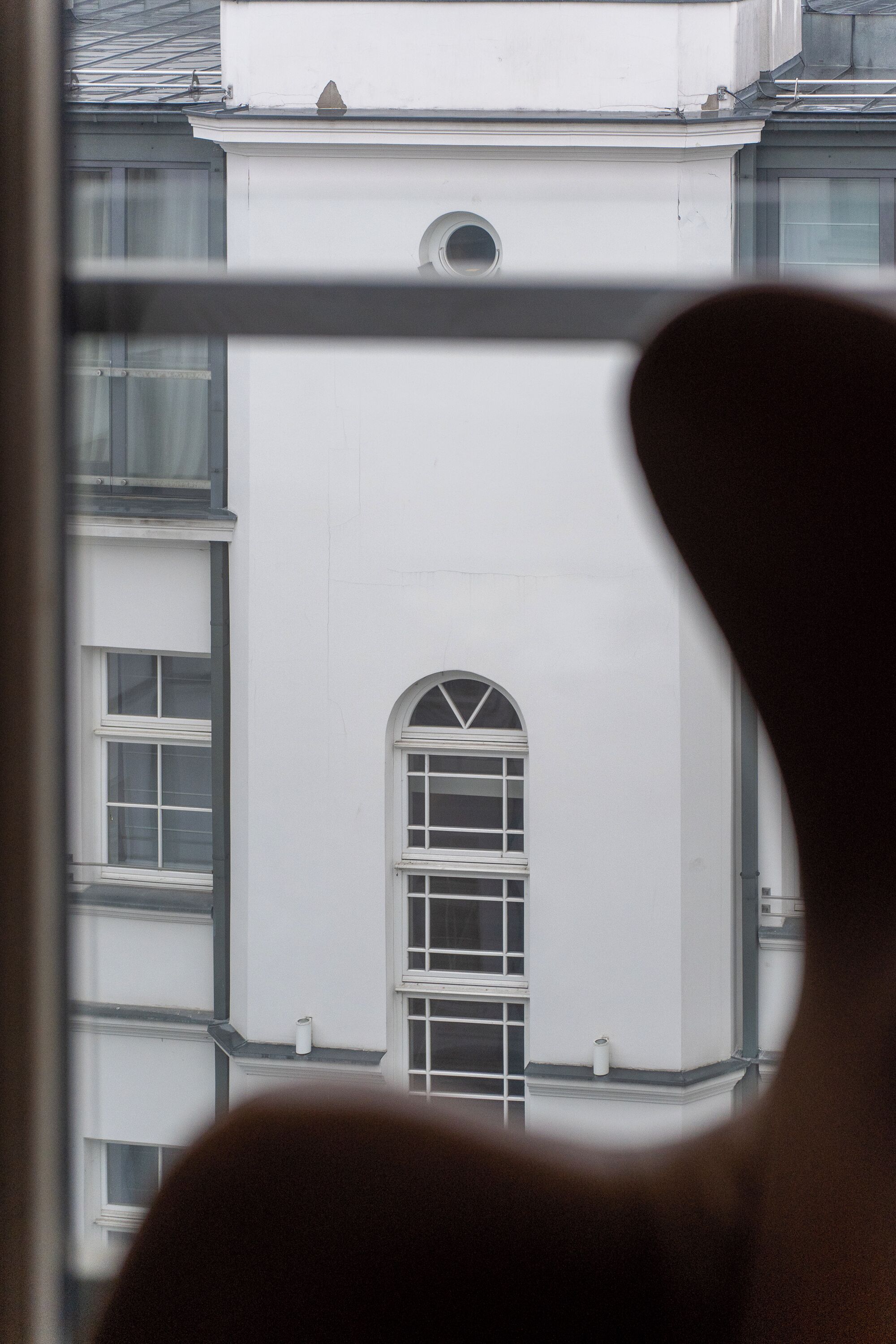 A building with a large arched window and multiple smaller windows.