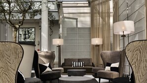 A modern lounge area with a sofa set, two side tables, and a coffee table.